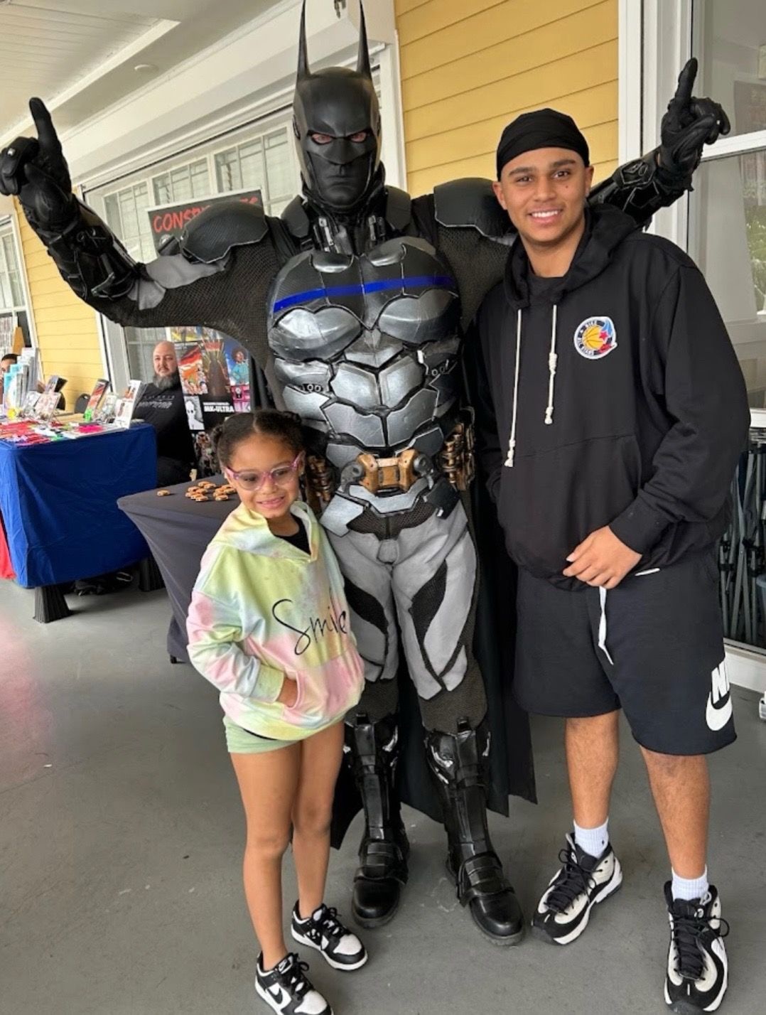 Batman posing with a family